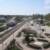 Western view from condos of train station and construction of fountain.